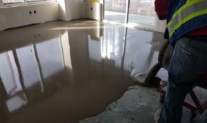 A professional pouring epoxy floor coating