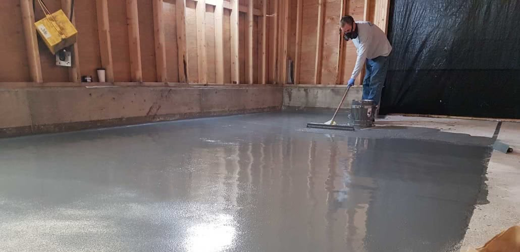 Worker leveling concrete