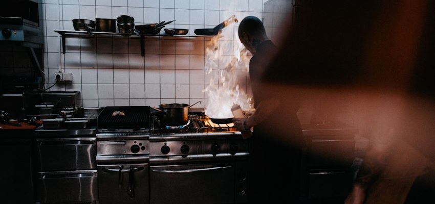 cook working over open fire